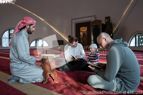 Image of muslim people in mosque reading quran together