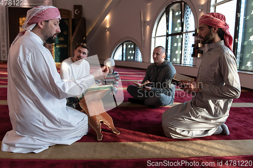 Image of muslim people in mosque reading quran together