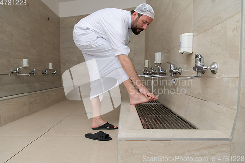 Image of A Muslim takes ablution for prayer. Islamic religious rite