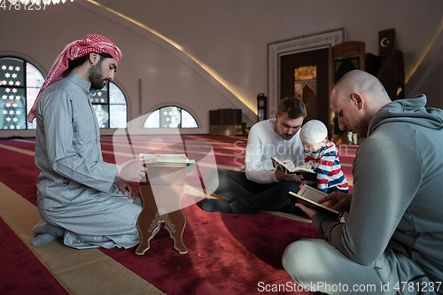 Image of muslim people in mosque reading quran together