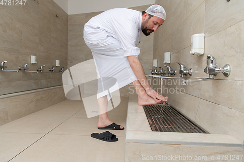 Image of A Muslim takes ablution for prayer. Islamic religious rite