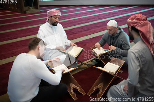 Image of muslim people in mosque reading quran together