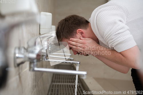 Image of A Muslim takes ablution for prayer. Islamic religious rite