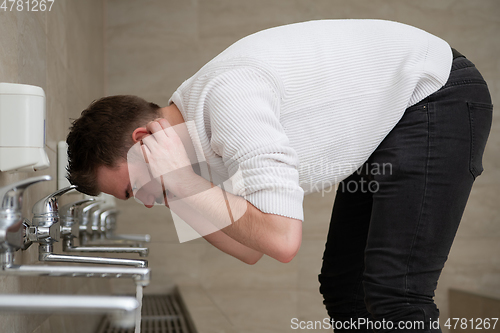 Image of A Muslim takes ablution for prayer. Islamic religious rite