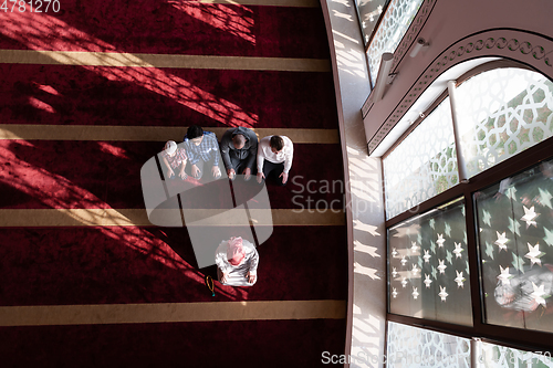 Image of group of muslim people praying namaz in mosque.