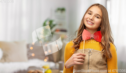 Image of happy teenage girl with red bowtie party accessory