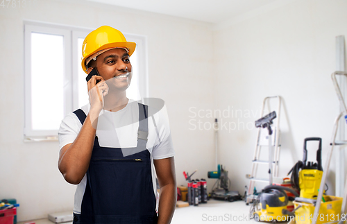 Image of indian builder in helmet calling on smartphone