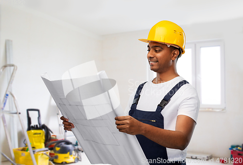 Image of happy indian builder in helmet with blueprint