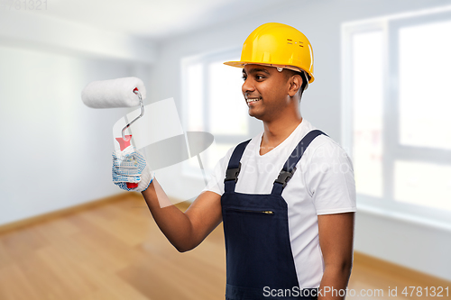 Image of happy indian painter or builder with paint roller