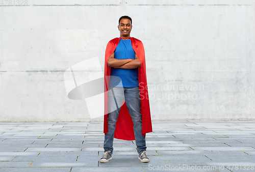 Image of indian man in red superhero cape with arms crossed