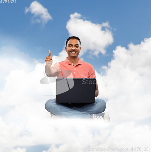 Image of happy indian man with laptop showing thumbs up