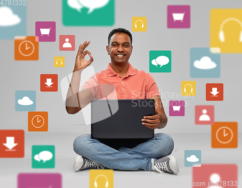 Image of happy indian man with laptop computer showing ok