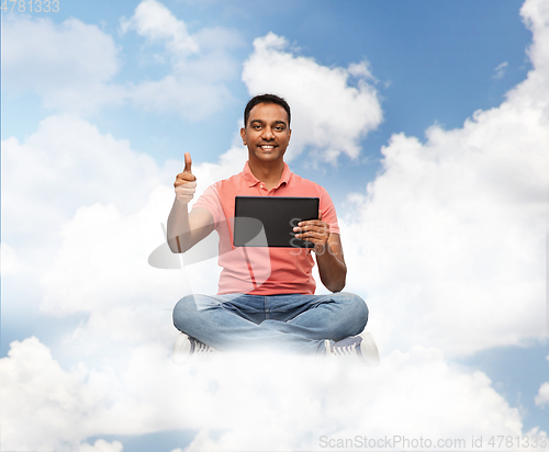 Image of happy indian man with tablet pc showing thumbs up