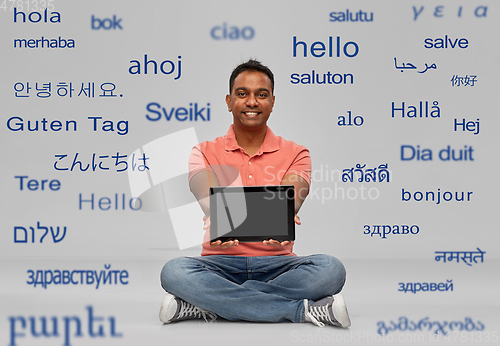 Image of happy indian man with tablet pc