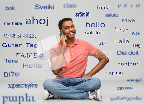 Image of happy indian man calling on smartphone