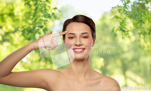 Image of beautiful young woman showing her forehead