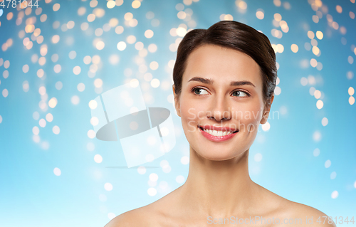 Image of beautiful smiling young woman with bare shoulder