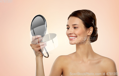 Image of beautiful young woman looking to mirror