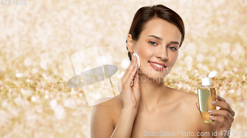 Image of young woman with toner or cleanser and cotton pad