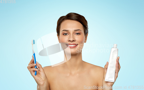 Image of smiling woman with toothbrush cleaning teeth