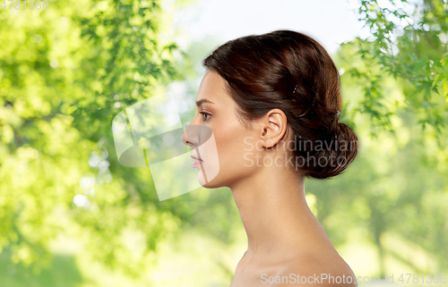 Image of profile of beautiful woman with bare shoulders