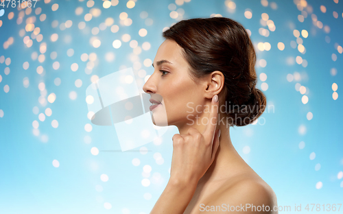 Image of beautiful young woman pointing finger to her ear