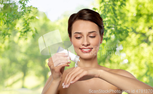 Image of woman applying moisturizing cream to her hand