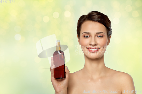 Image of beautiful young woman with sun protective oil