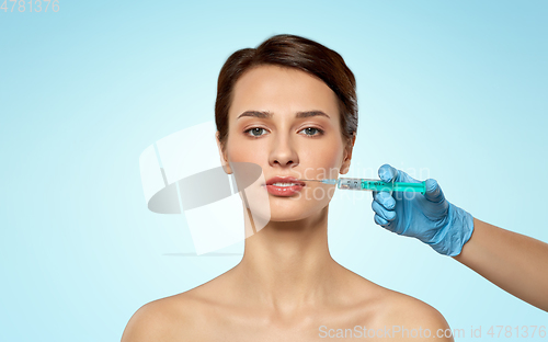 Image of beautiful young woman and hand with syringe