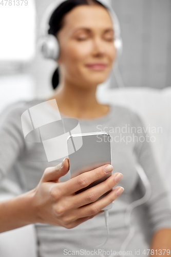 Image of close up of woman with smartphone and headphones