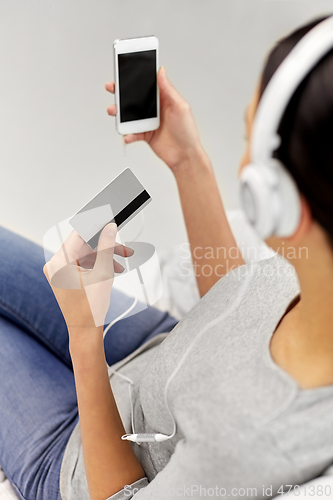 Image of close up of woman with smartphone and headphones