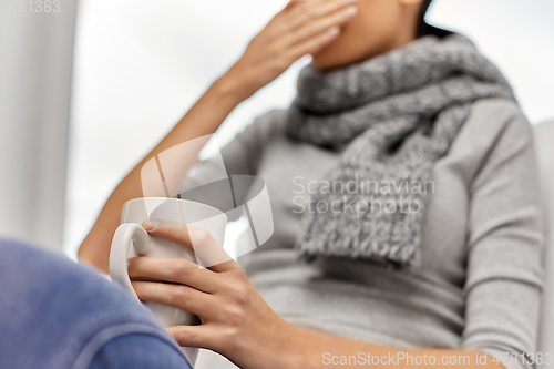 Image of close up of ill woman drinking tea at home