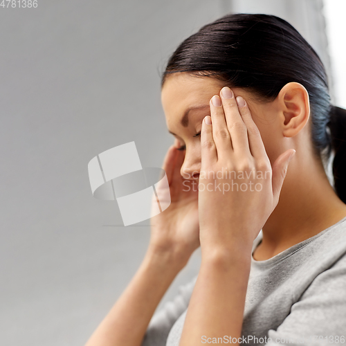 Image of close up of unhappy woman having headache