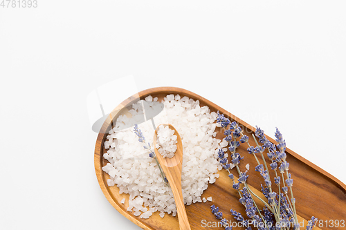 Image of sea salt heap and lavender on wooden tray