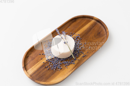 Image of close up of crafted lavender soap on wooden tray