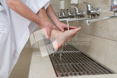 Image of A Muslim takes ablution for prayer. Islamic religious rite