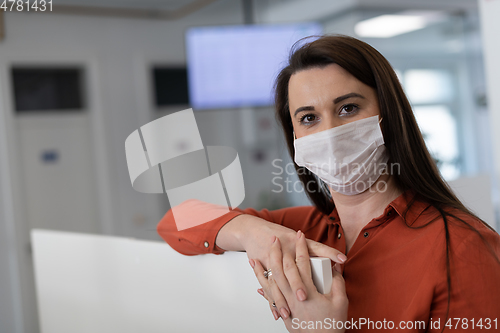 Image of call center operator in medical mask