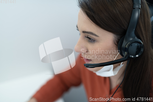 Image of call center operator in medical mask