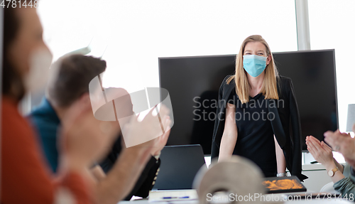 Image of real business people on meeting wearing protective mask