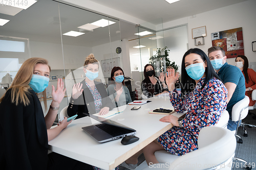 Image of real business people on meeting wearing protective mask