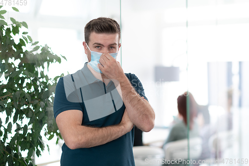 Image of young business man portrait in medical protective mask