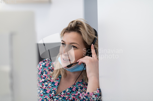 Image of call center operator in medical mask