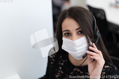 Image of call center operator in medical mask