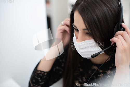 Image of call center operator in medical mask