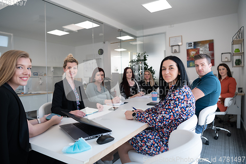 Image of real business people on meeting wearing protective mask