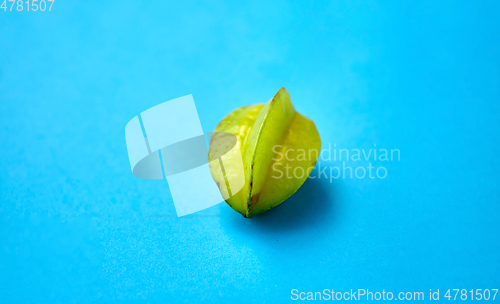 Image of ripe carambola or star fruit on blue background