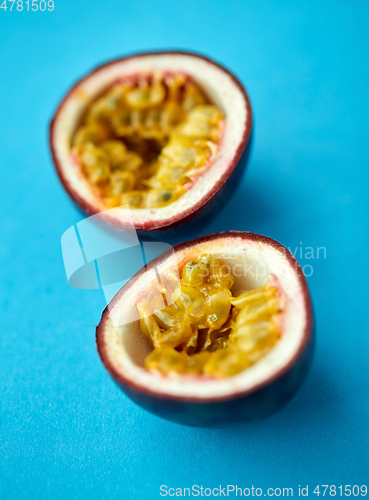 Image of cut passion fruit on blue background