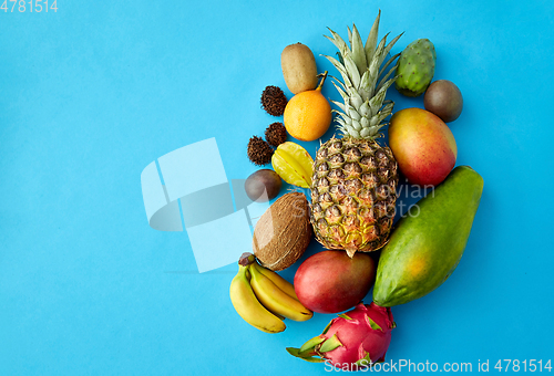 Image of many different exotic fruits on blue background