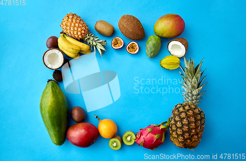 Image of different exotic fruits on blue background