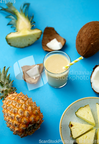 Image of pineapple, coconut and drink with paper straw